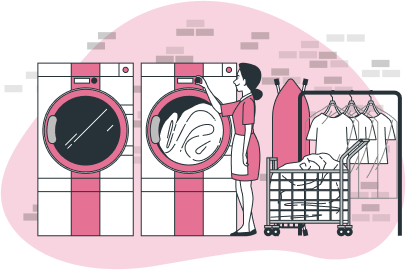 Kobieta w fartuchu obsługuje profesjonalne pralki w pralni. Obok widoczny wózek z praniem i wiszące, wyprasowane ubrania.